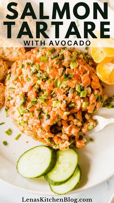 salmon tartare with avocado and cucumbers on a white plate