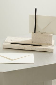 a pen is sitting on top of a piece of paper next to some envelopes