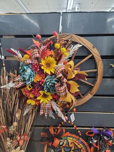 a bouquet of flowers is hanging on the wall next to other decorations and decor items