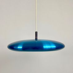 a blue light hanging from a white ceiling