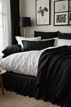 black and white bedding in a bedroom with pictures on the wall