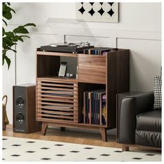 a record player sitting on top of a wooden cabinet