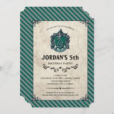 a harry potter birthday party card on a marble table with green and white striped paper