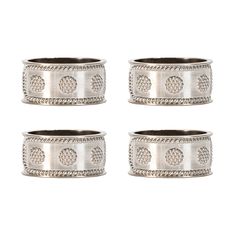 four silver napkin rings with beading on each side and an intricate design in the middle