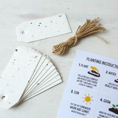 seed packets are laid out on a table next to the instructions for planting instruction cards