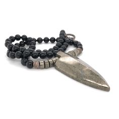 "This necklace was designed for the inner warrior with genuine Black Onyx and Pyrite 6mm beads. A large Pyrite arrow represents strength and power.  This really cool men's necklace is strung on the highest quality stainless steel beading wire for maximum strength and flexibility, then finished with a toggle clasp. Large Pyrite Arrows are approximately 2\" tall x 1 ⅞\" wide at the top. May your day be amazing, Saging Karma® 🦋 More Gemstone Necklaces https://www.etsy.com/shop/SagingKarma?ref=seller-platform-mcnav&section_id=27598570 Return to Saging Karma® shop: https://www.etsy.com/shop/SagingKarma?ref=seller-platform-mcnav Invoices will be included upon request. ✍︎  Orders totaling over $249.00 are shipped with signature required for delivery. © 2023 Saging Karma® Portland, Oregon.  All p Artisan Black Necklace With Oxidized Finish, Spiritual Silver Hematite Necklace, Adjustable Silver Obsidian Necklace, Spiritual Silver Obsidian Necklace, Spiritual Hematite Jewelry With Polished Beads, Black Hand Forged Spiritual Necklace, Black Hand-strung Amulet Jewelry, Black Warrior Style Jewelry As Gift, Black Warrior Style Jewelry For Gift