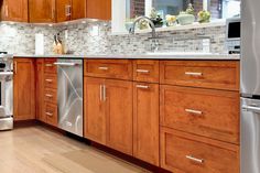 a kitchen with wooden cabinets and stainless steel appliances