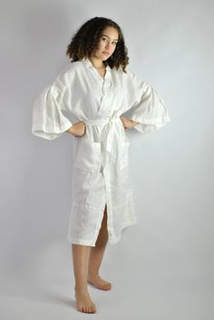 "This is our no. 60 of Conscious Clothing Concept #stayhome This lovely white A-line loose fitting robe is made of pure quality linen. Very modern approach to traditional white spa gown. It has got very flattering wide sleeves that match the bottom of the dress. This unique piece of loungewear can be very versatile. It is great and comfy to wear around the house, hotel or spa. It can be treated as the dress or loose shirt over the shorts for summer look. Perfect for home and the beach. It is the White Dress With Belt, Conscious Clothing, Big Sleeves, Gown White, Summer Office, Linen White, Loose Shirt, Dress With Belt, Womens Robes