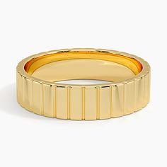 a yellow gold ring with vertical lines on the outside, and horizontal stripes on the inside