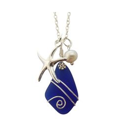 a blue sea glass necklace with a starfish and pearl hanging from it's end