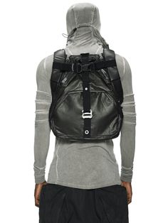 the back view of a person wearing a black backpack with a hoodie on it