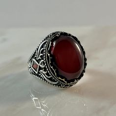 This stunning ring showcases a rich red agate stone, set in an intricately crafted silver band with vintage-inspired filigree details. The deep, vibrant hue of the agate combined with the traditional craftsmanship gives the ring a bold yet elegant appearance. Perfect for special occasions or adding a statement to everyday outfits, this piece is designed to catch the eye and exude sophistication. Its unique design blends the timeless charm of antique styles with a modern touch, making it a stando Red Stone Ring, Vintage Inspired Rings, Ring Antique, Red Agate, Red Stone, Agate Stone, Ring Vintage, Antique Style, Stone Ring