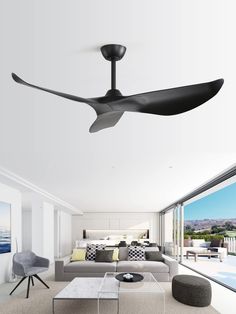 a living room filled with furniture and a ceiling fan