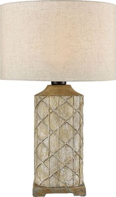 a table lamp with a white shade on it and a beige fabric covering over the base