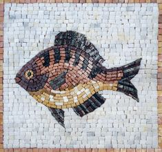 a mosaic fish is shown on the ground