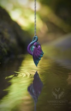 🏰Embark on a journey into the realm of enchantment with this cute dragon necklace in purple and teal shade! This beautiful dragon pendant will serve you not just as an accessory, but as a wise guardian and spirit companion! 🔮In the world of magic, Teal color is often associated with the communication with water spirits, serving as their conduct and inviting their guidance and wisdom into our world, while the shades of Purple symbolize the secrets and mysteries, reflecting the enigmatic nature Handmade Purple Fantasy Necklaces, Handmade Purple Fantasy Necklace, Handmade Purple Fairycore Jewelry, Fairycore Purple Necklace For Gift, Mystical Handmade Purple Necklace, Mystical Purple Necklace For Festivals, Purple Fantasy Necklace For Gift, Handmade Mystical Purple Necklace, Fantasy Style Purple Necklace For Gift