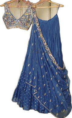 Blue Bollywood Embellished Pre-draped Saree, Festive Blue Embellished Pre-draped Saree, Fitted Pre-draped Saree With Dabka Work For Party, Blue Embellished Semi-stitched Pre-draped Saree, Eid Festival Set With Dupatta And Long Skirt, Eid Festival Long Skirt Set With Dupatta, Embellished Blue Anarkali Pre-draped Saree, Designer Dresses With Sheer Dupatta And Long Skirt, Dola Silk Dress With Traditional Drape For Reception