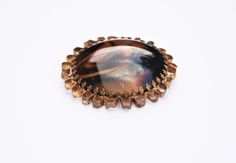 "A beautiful large retro brooch. A marbled brown porphyr glass cabochon has been claw set into a gold tone casting, to create this bold statement piece.  Measurements: 1.96\"/50mm diameter Condition: Good condition, with age related discolouration to the plating throughout - please take a look at the photographs. All purchases are sent out securely boxed, with an organza gift bag! Thanks for looking :) If you would like to see more vintage costume jewellery, visit the Retrorox Shop: https://www. Mid-century Cabochon Brooch For Gift, Mid-century Cabochon Brooch Gift, Mid-century Cabochon Brooches For Gifts, Vintage Brown Jewelry Brooch, Vintage Brown Brooch Jewelry, Brown Brooch Jewelry Gift, Brown Jewelry Brooch For Gifts, Vintage Brown Brooch For Collectors, Vintage Brown Brooches Collectible