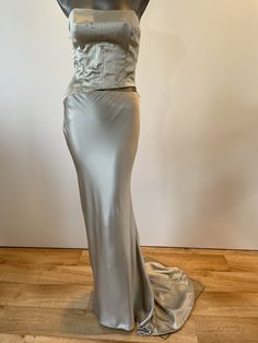 A unique opportunity to own a beautiful Vintage Caroline Holmes Couture Gown at just 10% of it's original value from our Knightsbridge Salon.  The Gown is handmade from the finest silks, silk lined to create that extra special feeling of elegance to it's wearer. Description: Silver bias cut gown with sculptured paneled bodice with crystal detail. Low back, bias-cut skirt into train.  Side concealed zipper fastening.  Cutaway skirt to approx. high hip with crystal detail.  Cutaway can be adjusted Couture Gown, Bias Cut Skirt, Nape Of Neck, Couture Gowns, Low Back, Dress Clothes For Women, Skirt Length, Halloween Shopping, Favorite Outfit