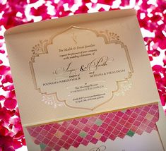 the inside of a wedding card with pink flowers in the background and gold foil on it