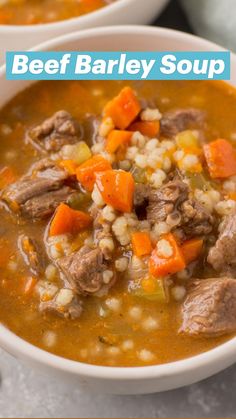 two bowls of soup with carrots, meat and rice on the side next to a spoon