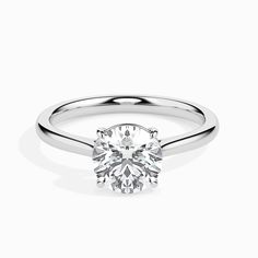 a white gold ring with a round brilliant diamond