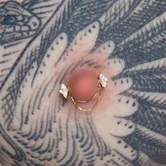 a woman's breast with two small diamonds on it