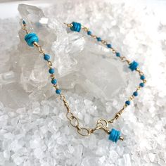 Beautiful Sleeping Beauty Heshi Turquoise beads (that amazing bright blue color) are stationed along this dainty rosary style chain with tiny 2mm Turquoise round beads.Entire bracelet is hand-wrapped to keep it secure. Finished off with a dangle of the same pretty Sleeping Beaty Heshi Turquoise beads, gold filled beads and spring ring clasp. Length is adjustable from 6 3/4" - 7 1/4". Great simple bracelet for everyday, December Birthdays, date night! Great layering bracelet. Dainty Adjustable Rosary Bracelet With Tiny Beads, Dainty Blue Round Bead Bracelets, Adjustable Bracelet With Satellite Chain And Round Beads, Adjustable Beaded Bracelets With Satellite Chain, Adjustable Satellite Chain Beaded Jewelry, Adjustable Satellite Chain Jewelry With Round Beads, Dainty Blue Beaded Chain Bracelet, Dainty Rosary Bracelet Gift, Handmade Dainty Rosary Bracelet