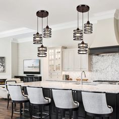 a large kitchen with an island and bar stools