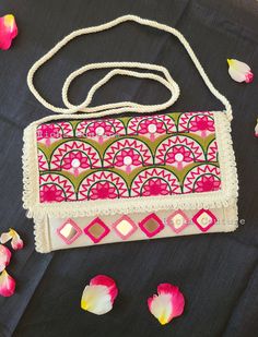 ~ Handcrafted boho sling bag: A perfect blend of rustic charm and effortless style ♥️ ~ It is handmade with beautiful aari and real mirror work✨️ ~ It has sling belt attached. Use it with or without sling belt ~ Pair it up with your ethnic or western wear ~ For any query contact us at 360-901-9890 Handmade Rectangular Potli Bag, Bohemian Potli Bag With Handwork, Handmade Beige Bags For Festive Occasions, Pink Rectangular Shoulder Bag With Handwork, Festive Mirror Work Pouch Shoulder Bag, Festive Beige Rectangular Shoulder Bag, Bohemian Handmade Potli Bag For Everyday Use, Bohemian Pouch Clutch With Adjustable Strap, Bohemian Shoulder Bag With Woven Motifs