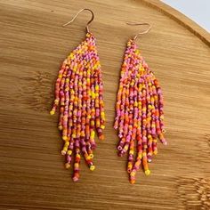 Get into the Summer Vibes with our Sunset Blush Fringe Earrings! These fun and playful earrings feature a vibrant mix of pink and orange beads, perfect for adding a pop of color to any outfit. Let these beaded fringe earrings be the statement piece of your summer look! Sunset Blush, Playful Earrings, Beaded Fringe Earrings, Beaded Fringe, Fringe Earrings, Summer Look, Handmade Bags, Summer Looks, Summer Vibes