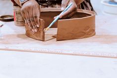 a person is working on a clay sculpture