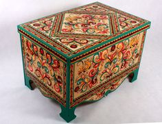 an ornately painted wooden box sitting on the floor