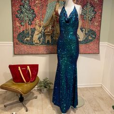 Fashion Nova Sequin Mermaid Gown, Features A Halter Cowl Neckline With Adjustable Black Satin Ties At Neck, Backless With An Exposed Black/Silver Tone Zipper. Size Xs Has A Bit Of Stretch And Is A Snug Fit On My Size 2/4 Mannequin. Brand New With Tags And Sold Out Everywhere. Dress Is Such Gorgeous Greens/Blues- Very Striking. Fitted Mermaid Gown With Sequins, Glamorous Blue Mermaid Evening Dress, Glamorous Mermaid Gown For Homecoming, Blue Sequined Mermaid Dress For Homecoming, Blue Mermaid Dress With Sequins For Homecoming, Blue Fitted Bodice Backless Gown, Blue Backless Gown With Fitted Bodice, Blue Mermaid Gown For Prom Season, Blue Mermaid Gown For Prom