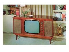 an old fashioned television sitting on top of a table