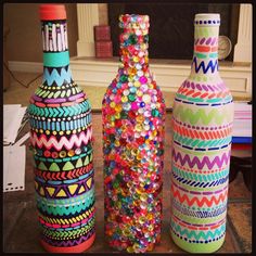 three colorful vases sitting next to each other