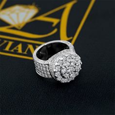 DESCRIPTION: This magnificent mens diamond ring is handcrafted in lustrous 14K white gold and features a high-polished shimmering look. The center and the sides of the ring are set with dazzling natural icy- white round cut diamonds which total to 5.50 carats. The frame measures to 17 mm in width and weighs 17.5 grams. Stand out with this one of a kind mens diamond custom pinky ring!  DETAILS: Item Code 6478-1 Diamond Carat Weight 5.50 Ctw Diamond Clarity VS1, VS2 Diamond Color G, H Metal Color Based on Gold Color Selection Metal Type 14K Gold Item Weight 17.5 grams Width 17 mm Mens Diamond Pinky Rings, Black Diamond Chain, Square Diamond Earrings, Mens Diamond Ring, Mens Diamond Earrings, Black Diamond Bracelet, Diamond Solitaire Earrings, Black Diamond Earrings, Solid Gold Bracelet