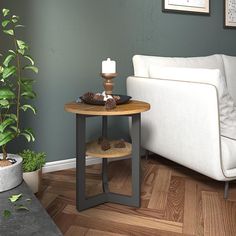 a living room with a couch, table and potted plant on the floor next to it