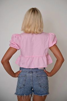 This vibrant pink cropped top combines playful elements with functional design, offering a fresh take on casual wear. Featuring a unique tie-front closure and ruffled details, this piece is perfect for those looking to add a splash of color and whimsy to their wardrobe. Features: Material: Made from a lightweight cotton blend, ensuring comfort and ease of wear. Special Features: This top includes a tie-front design that allows for adjustable fitting and adds a decorative touch. Technical Specifi Chic Cropped Ruffle Crop Top, Chic Cropped Hem Crop Top For Summer, Pink Flirty Crop Top With Ruffles, Flirty Pink Ruffled Crop Top, Spring Chic Crop Top With Ruffle Hem, Chic Spring Crop Top With Ruffle Hem, Fitted Ruffle Hem Crop Top For Summer, Chic Slightly Cropped Cotton Crop Top, Cotton Crop Top For Day Out With Cropped Hem