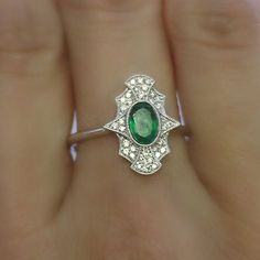 "This style we use a larger cut oval cut center stone adores with pave diamonds as inspiration from a mirror, truly gorgeous and classic. Material: 1 oval cut center emerald 0.43 carat. 34 diamonds of 0.13 carat, color GH, clarity SI. 18K solid gold. Measurement: approximately 15mm x11mm,depth 2mm Art deco is our most unique collection, it is rarely found anywhere else. We take the concept of vintage art deco jewelry and pour into our design and ideas to make it more modern and sophisticate piec White Gold Oval Emerald Ring Art Deco Style, Art Deco Green Emerald Ring With Rose Cut Diamonds, Oval Emerald Ring With Pave Diamond Setting, Art Deco Emerald Ring With Rose Cut Diamonds, Oval Emerald Ring With Diamond Pave Setting, White Gold Emerald Ring With Pave Setting, Oval Shape, Elegant Emerald Ring With Oval Cabochon, Elegant Oval Cabochon Emerald Ring For May Birthstone, Art Deco Oval Jewelry With Halo Setting