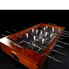 the foosball table is made out of wood and has several pieces of metal in it