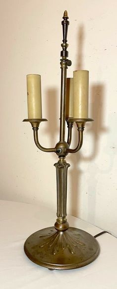 an antique brass candelabra with two candles