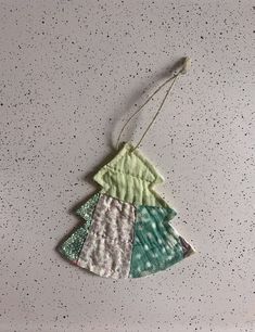 a christmas tree ornament hanging from a string