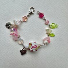 floral spring beaded bracelet!  --- a perfect staple for those pretty spring months  - with a pink, white and green mix of colors it is an all time fav Pink Bohemian Bracelets For Spring, Spring Pink Beaded Bracelets With Colorful Beads, Pink Whimsical Beaded Bracelets, Whimsical Pink Beaded Bracelets, Whimsical Pink Bracelets With Colorful Beads, Spring Pink Beaded Bracelets, Pink Beaded Flower Charm Bracelet, Pink Trendy Beaded Bracelets For Spring, Pink Flower-shaped Beaded Charm Bracelet