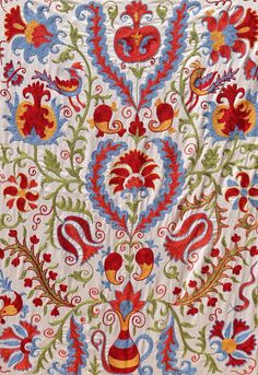 an embroidered fabric with red, blue and green designs