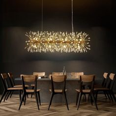 a modern chandelier hanging over a dining room table