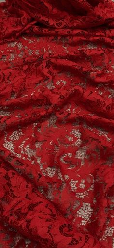 a red lace fabric with white flowers on it