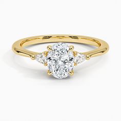 a yellow gold engagement ring with an oval cut diamond