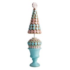 a blue vase with a pink and white decoration on it's top, sitting next to a smaller one that is shaped like a christmas tree