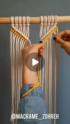 someone is holding the string on top of a macrame hammock